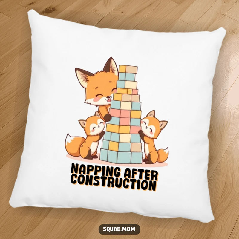 Funny decorative pillow showing a happy fox mom and kits engrossed in building a block tower, a cute humorous gift.