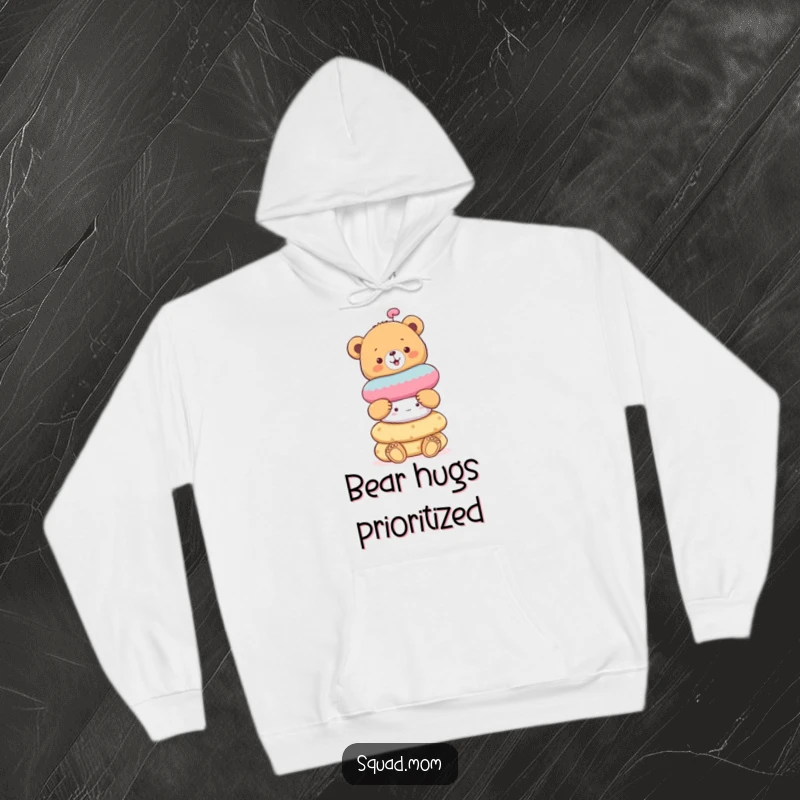 Funny cheerful bear cub balancing a stack of soft toys, a cozy and humorous hoodie for bear enthusiasts.