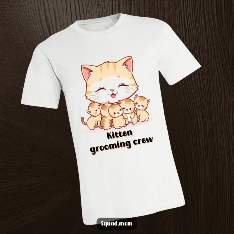 Funny Cat Mom T-Shirt showing a contented mother cat grooming her small, playful kittens, radiating warmth and humor.